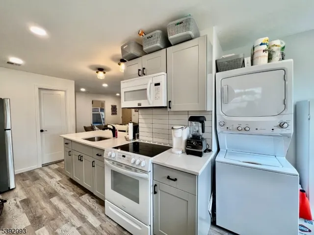 a kitchen with a stove and a white wooden cabinets