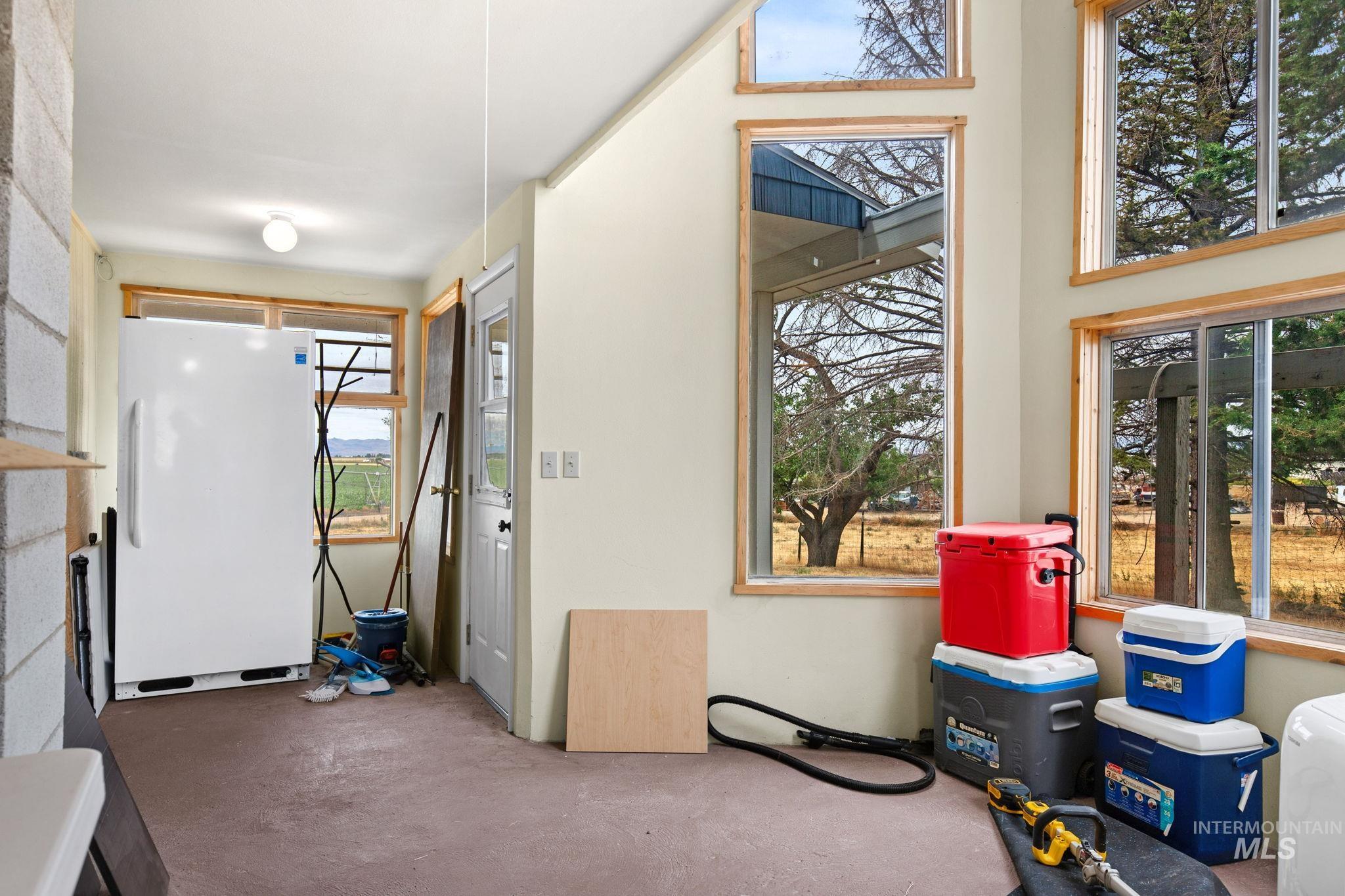 18338 Pride Lane Caldwell, ID 83607 - Photo 19 of 50 Room with multiple windows, light-colored walls, and wood-finish trim