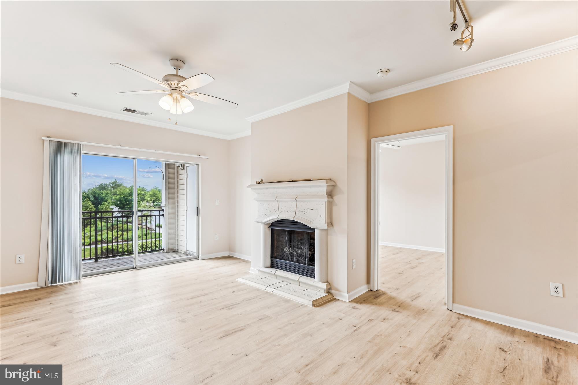 12941 Centre Park Circle, Unit 216 Herndon, VA 20171 - Photo 12 of 44 a view of empty room with fireplace and fan