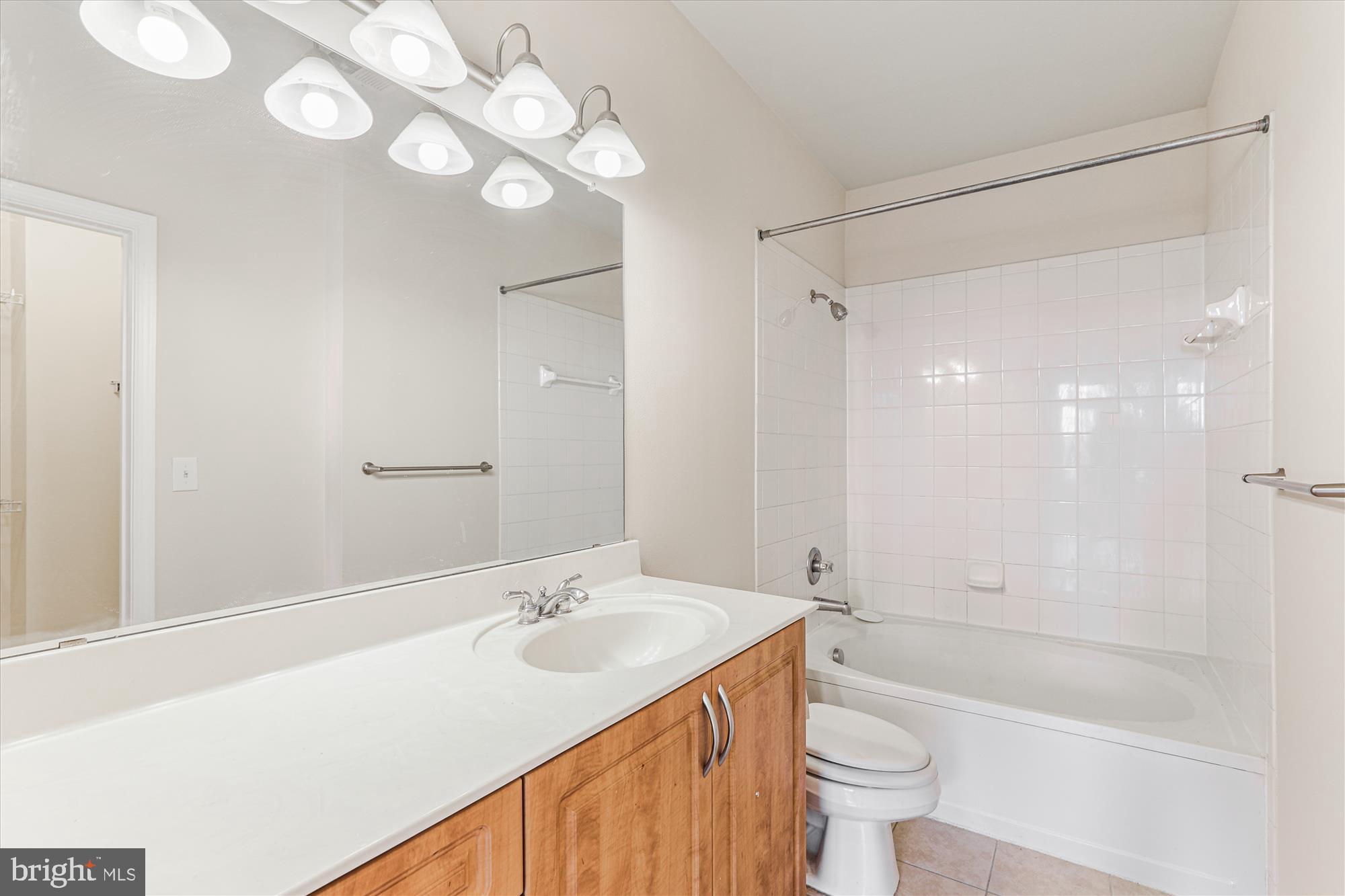 12941 Centre Park Circle, Unit 216 Herndon, VA 20171 - Photo 17 of 44 a bathroom with a sink a toilet and shower