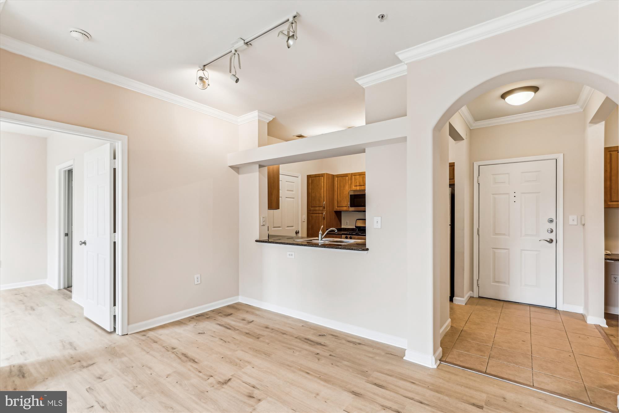 12941 Centre Park Circle, Unit 216 Herndon, VA 20171 - Photo 2 of 44 a view of a hallway with wooden floor and staircase
