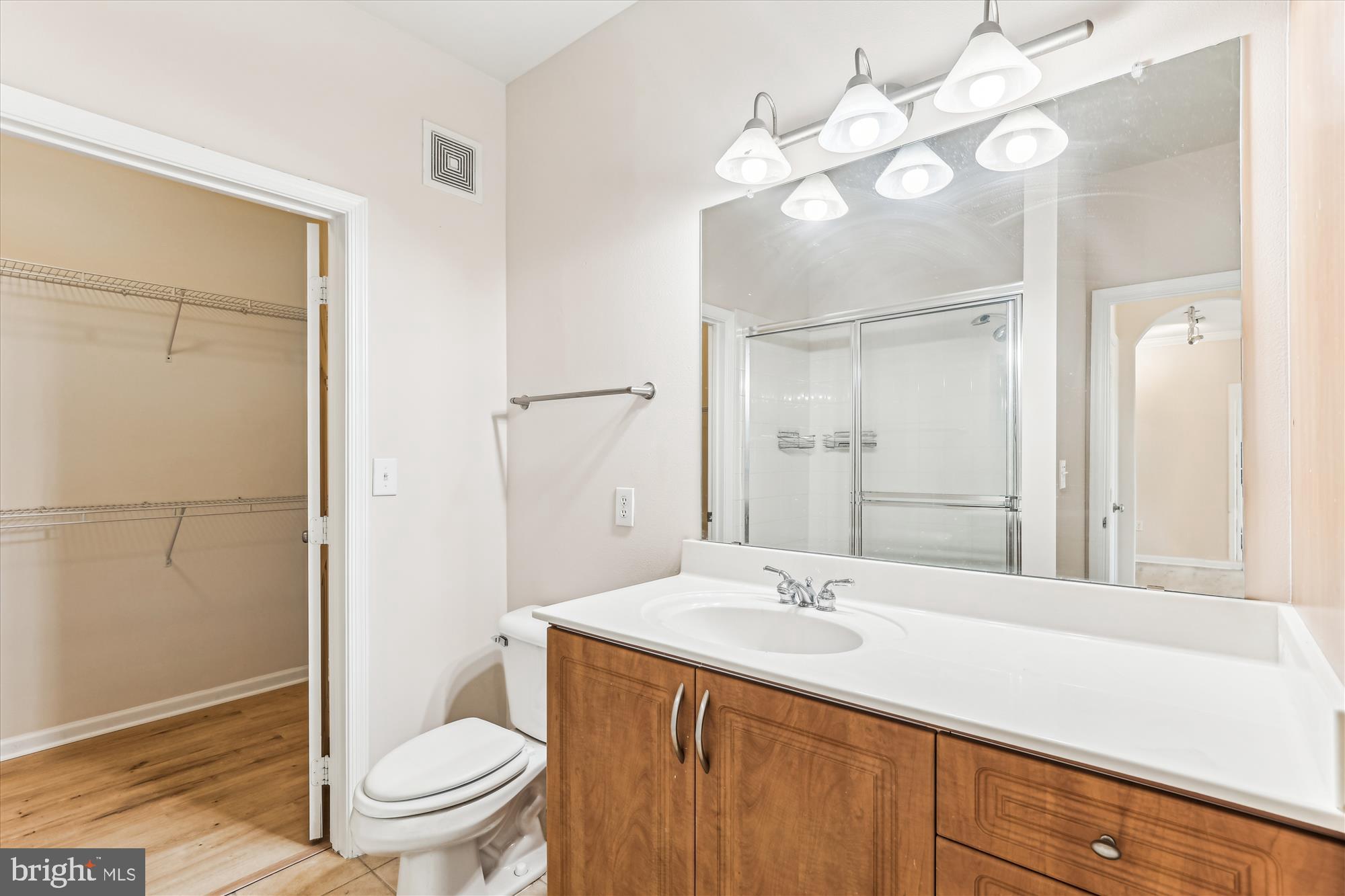 12941 Centre Park Circle, Unit 216 Herndon, VA 20171 - Photo 22 of 44 a bathroom with a sink a toilet and shower
