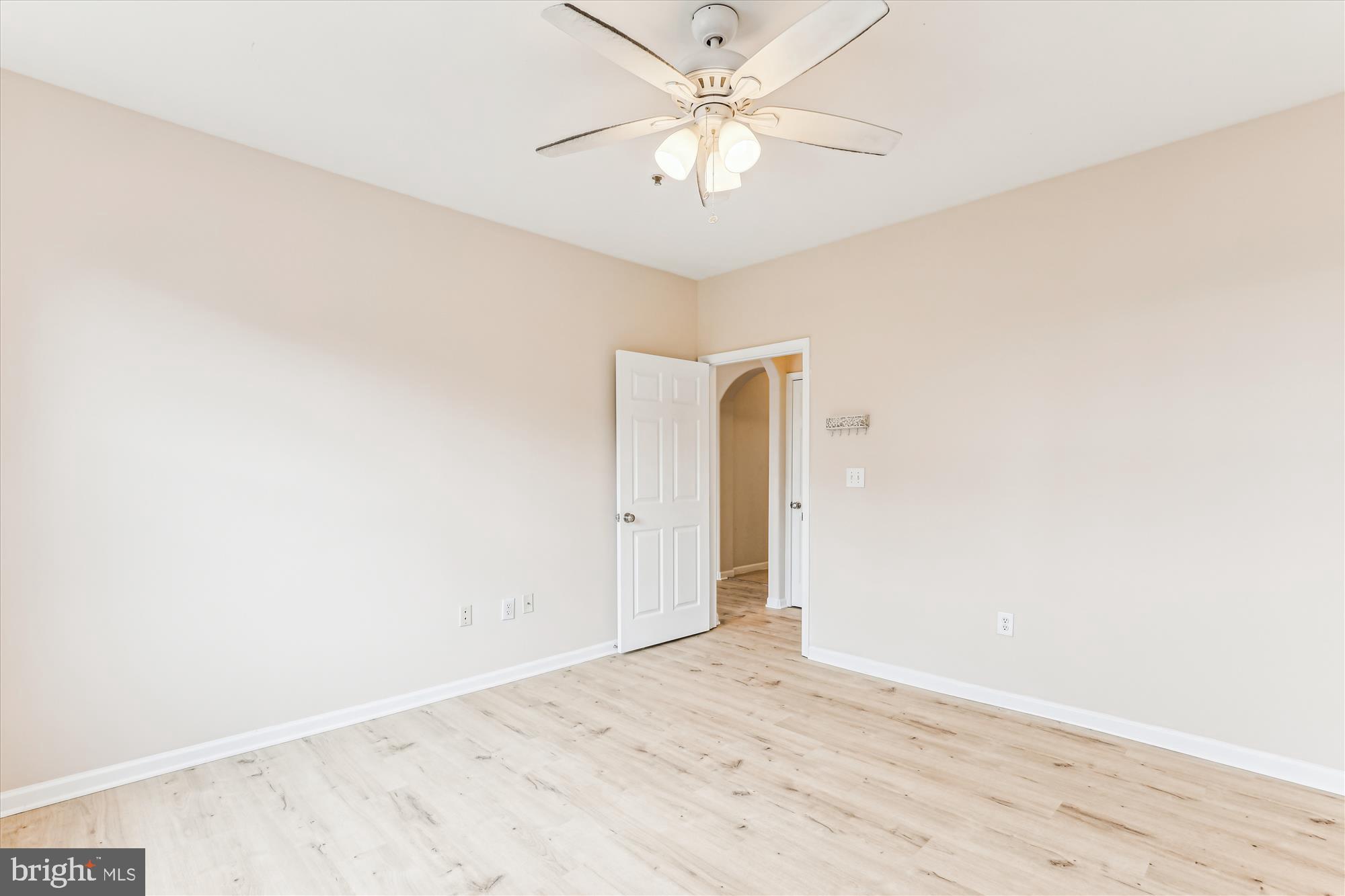12941 Centre Park Circle, Unit 216 Herndon, VA 20171 - Photo 23 of 44 an empty room with a ceiling fan and wooden floor