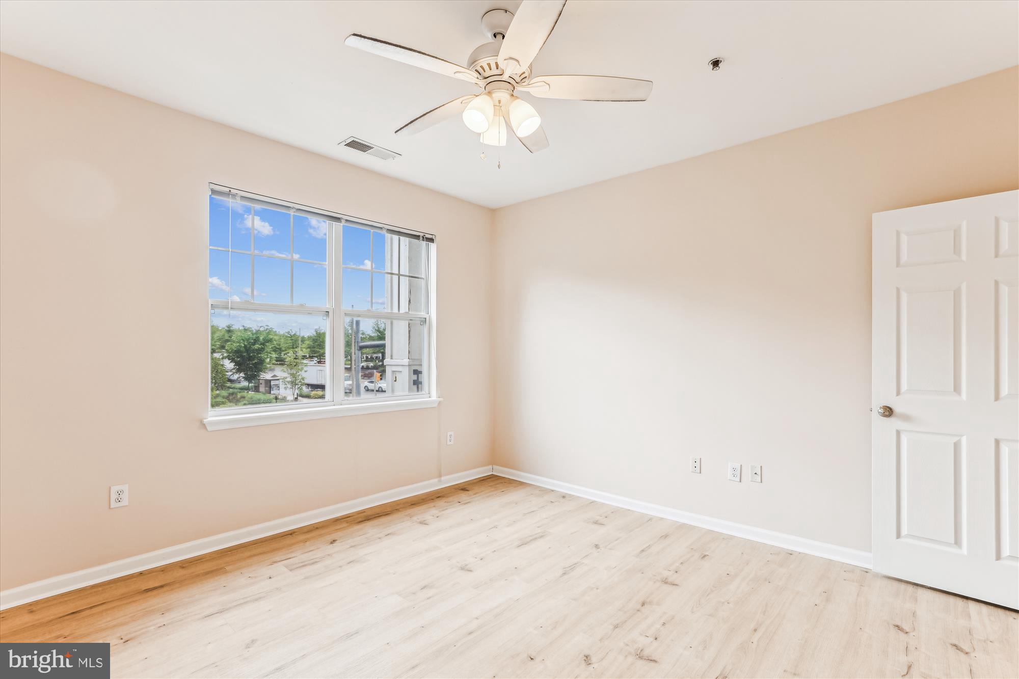 12941 Centre Park Circle, Unit 216 Herndon, VA 20171 - Photo 26 of 44 an empty room with a window and a ceiling fan