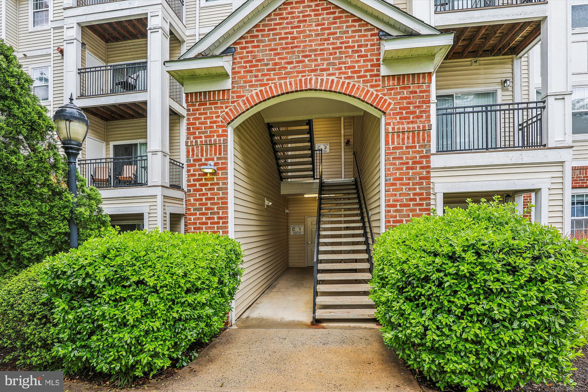 12941 Centre Park Circle, Unit 216 Herndon, VA 20171 - Photo 29 of 44 a front view of a house with a garden
