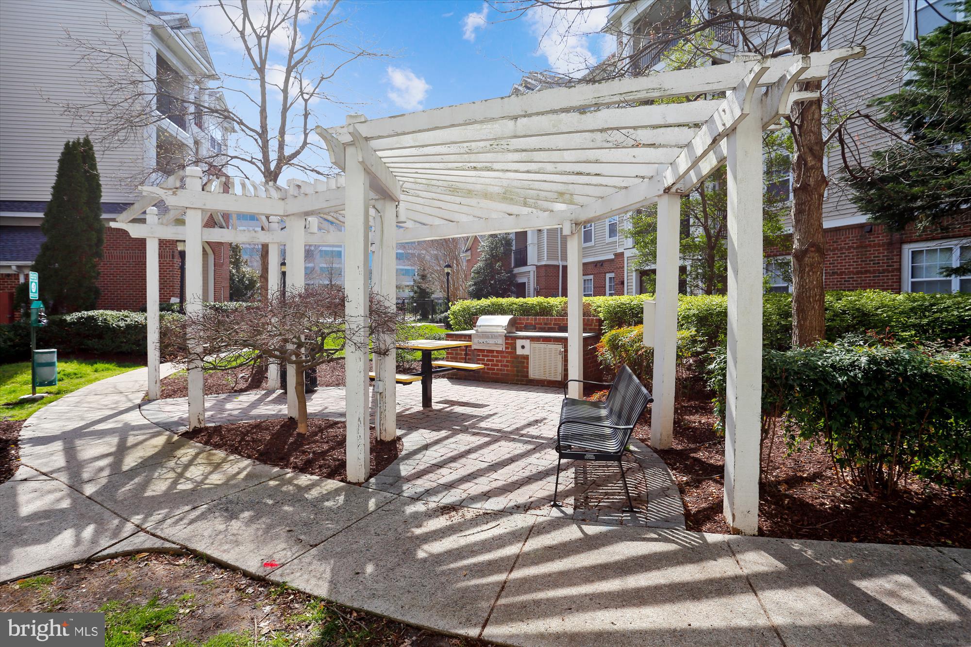 12941 Centre Park Circle, Unit 216 Herndon, VA 20171 - Photo 35 of 44 a view of a patio with couches chairs table and chairs