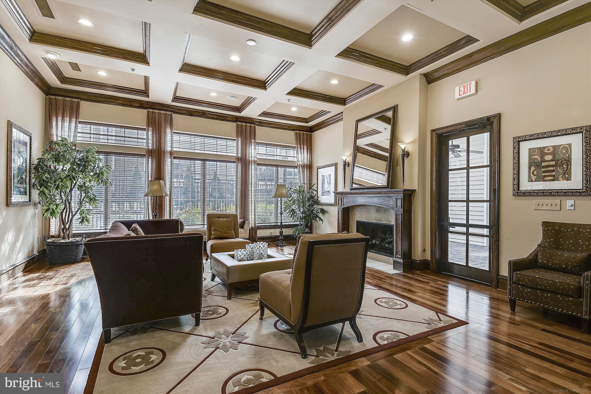12941 Centre Park Circle, Unit 216 Herndon, VA 20171 - Photo 39 of 44 a living room with furniture a fireplace and a floor to ceiling window