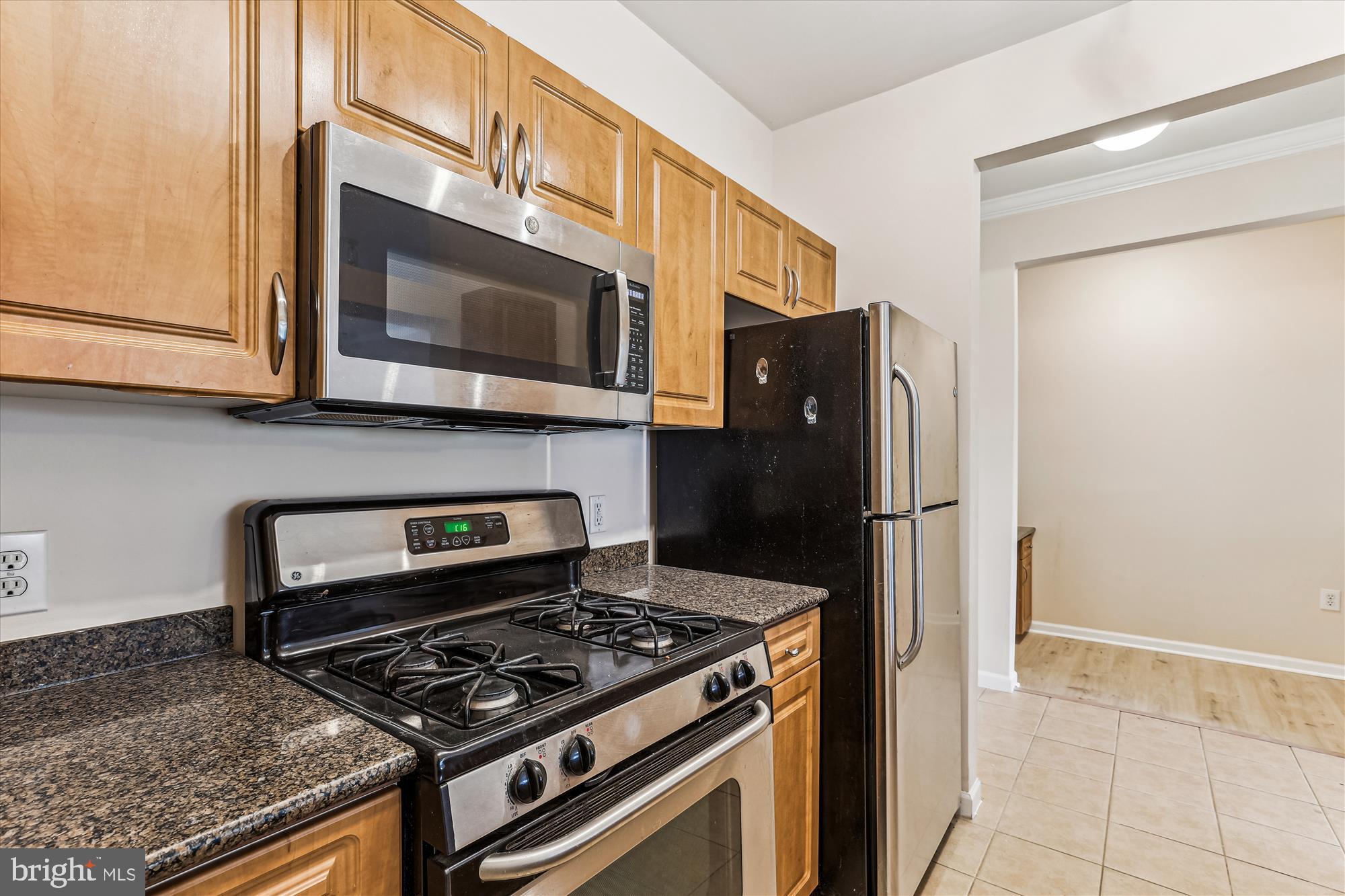 12941 Centre Park Circle, Unit 216 Herndon, VA 20171 - Photo 4 of 44 a kitchen with stainless steel appliances granite countertop a stove and a refrigerator