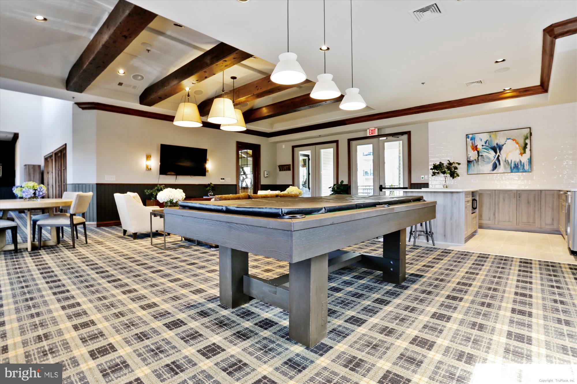 12941 Centre Park Circle, Unit 216 Herndon, VA 20171 - Photo 44 of 44 a living room with furniture a flat screen tv and kitchen view