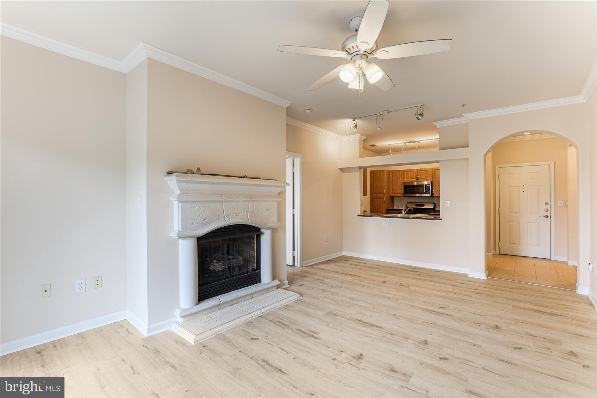 12941 Centre Park Circle, Unit 216 Herndon, VA 20171 - Photo 9 of 44 a view of an empty room with a fireplace and a window