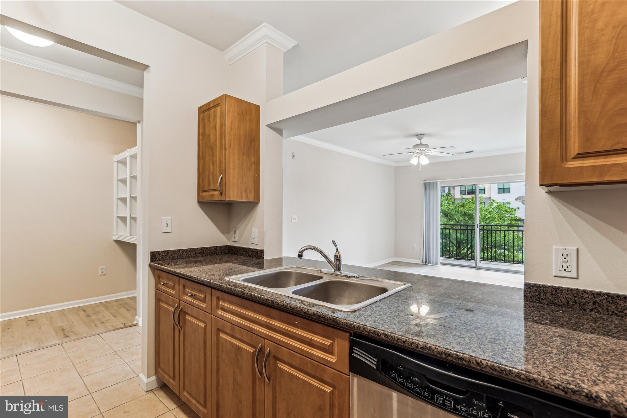 12941 Centre Park Circle, Unit 216 Herndon, VA 20171 - Photo 10 of 44 a kitchen with granite countertop a sink and a stove