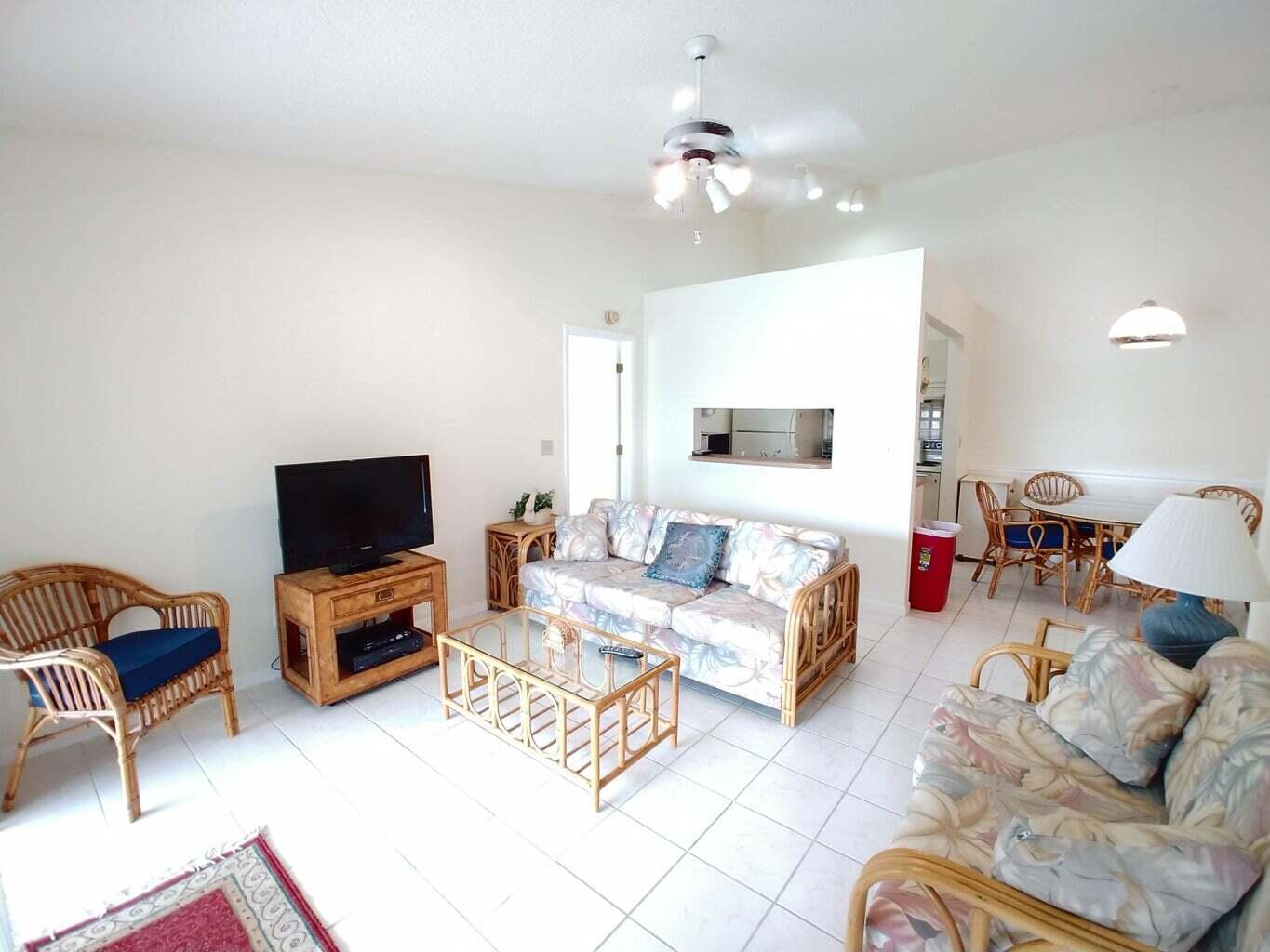 6258 Chasewood Drive, Unit E Jupiter, FL 33458 - Photo 4 of 15 a living room with furniture and a flat screen tv