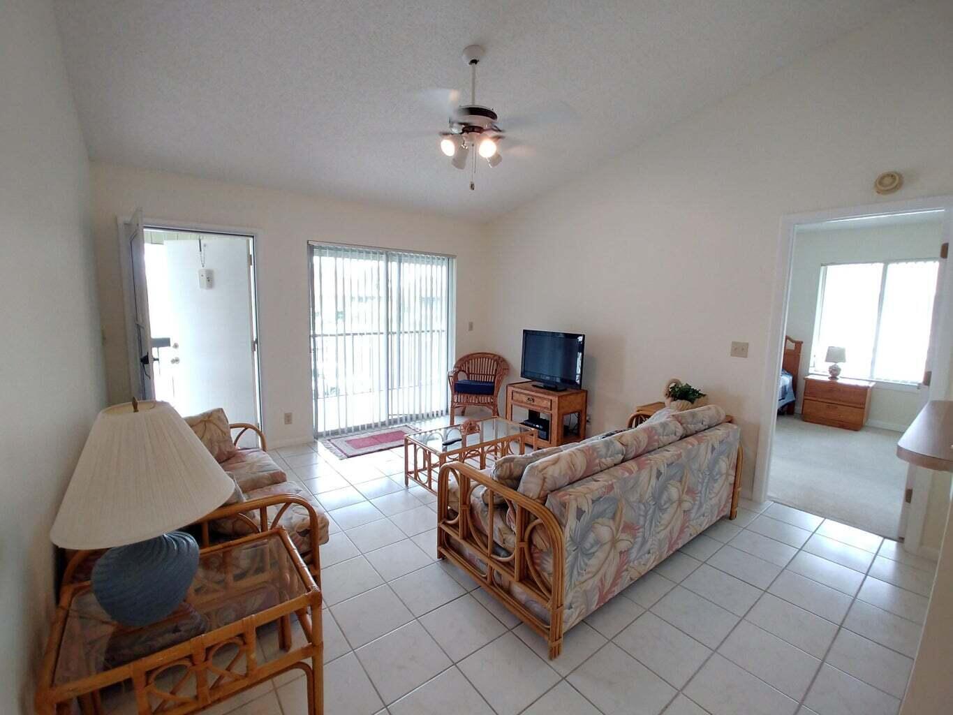6258 Chasewood Drive, Unit E Jupiter, FL 33458 - Photo 5 of 15 a bed room with bed and window