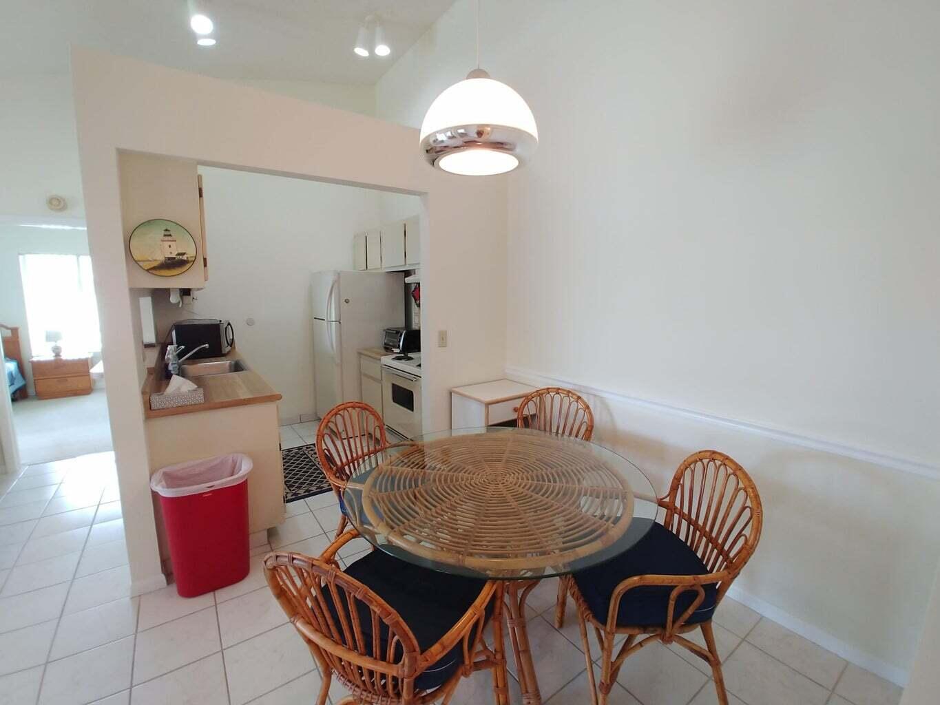 6258 Chasewood Drive, Unit E Jupiter, FL 33458 - Photo 6 of 15 a dining room with furniture and wooden floor