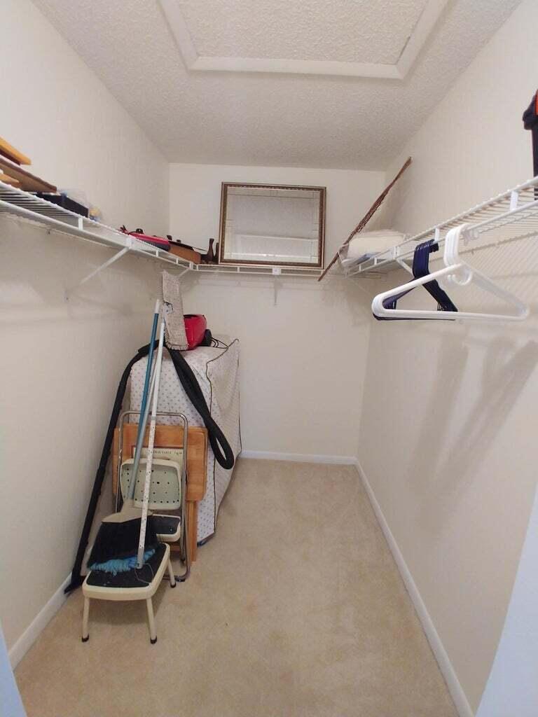 6258 Chasewood Drive, Unit E Jupiter, FL 33458 - Photo 10 of 15 a view of a room with rack on the wall