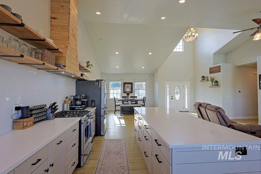 24 Harris Circle Shoshone, ID 83352 - Photo 38 of 39 Kitchen featuring recessed lighting, stainless steel appliances, open floor plan, a kitchen island, and light wood finished floors