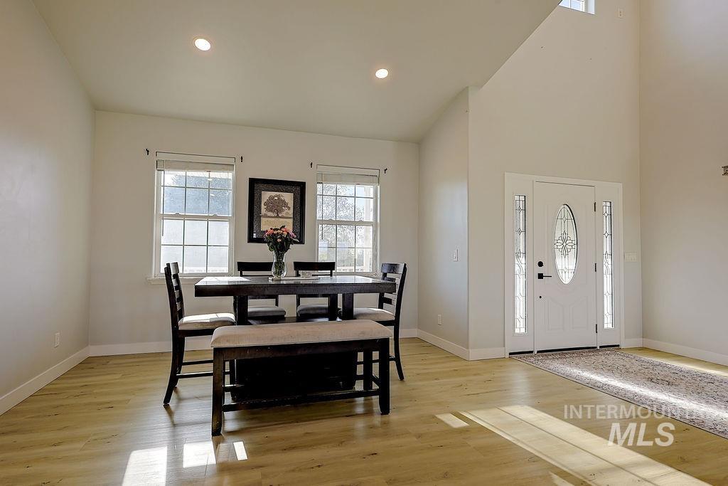 24 Harris Circle Shoshone, ID 83352 - Photo 14 of 39 Dining room with light wood-type flooring, recessed lighting, and a high ceiling
