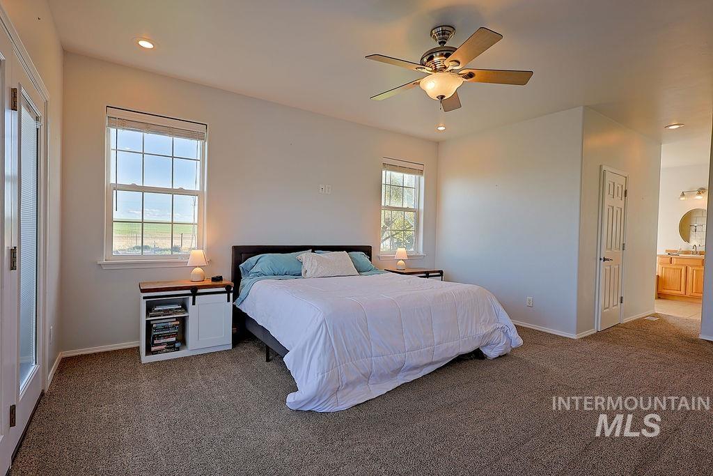 24 Harris Circle Shoshone, ID 83352 - Photo 15 of 39 Bedroom featuring recessed lighting, dark carpet, ceiling fan, and connected bathroom