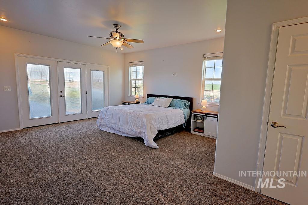 24 Harris Circle Shoshone, ID 83352 - Photo 16 of 39 Bedroom with access to outside, carpet flooring, recessed lighting, a ceiling fan, and multiple windows