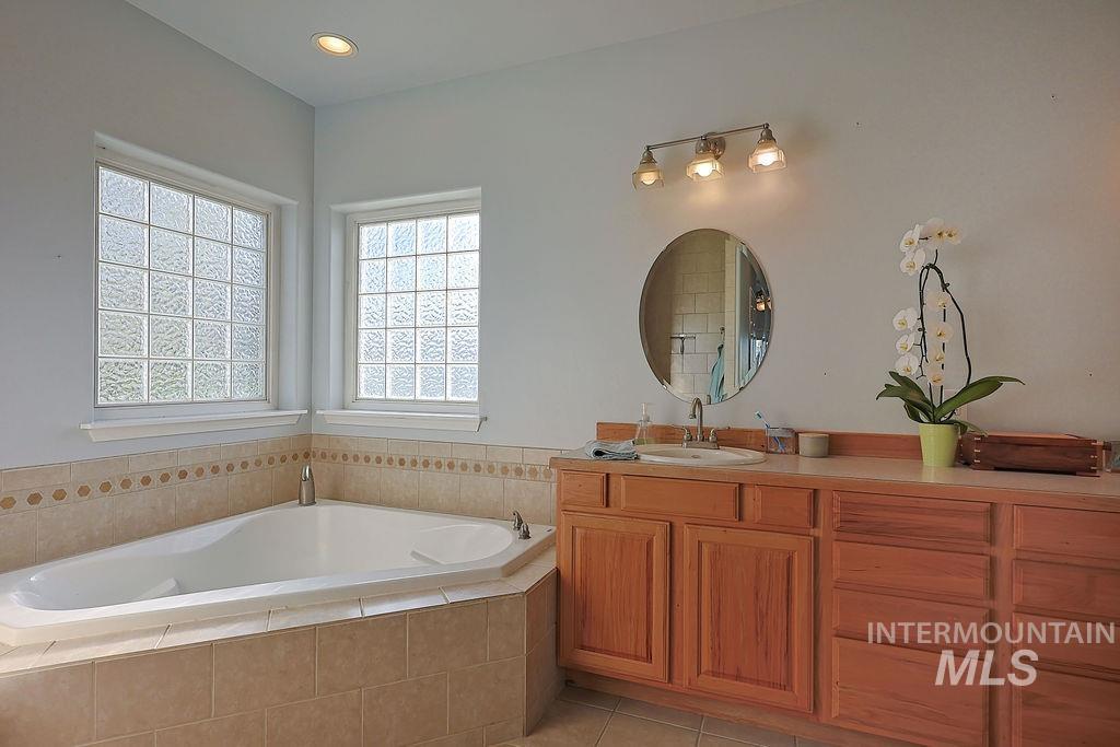 24 Harris Circle Shoshone, ID 83352 - Photo 18 of 39 Full bathroom featuring vanity, a garden tub, and light tile patterned flooring