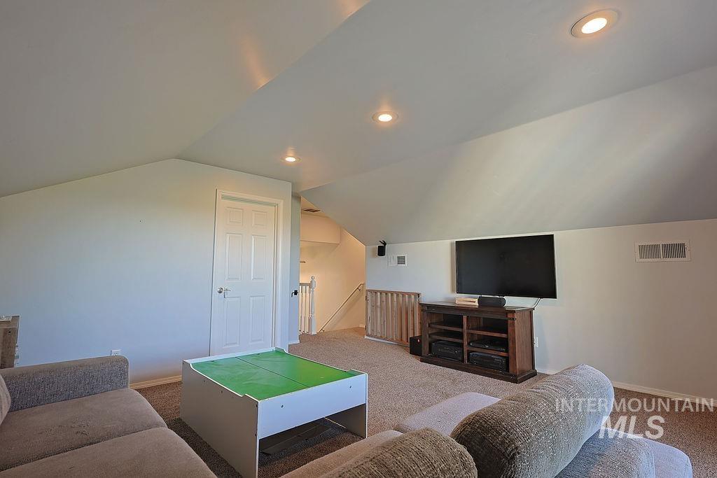 24 Harris Circle Shoshone, ID 83352 - Photo 23 of 39 Living room with recessed lighting, carpet flooring, and lofted ceiling