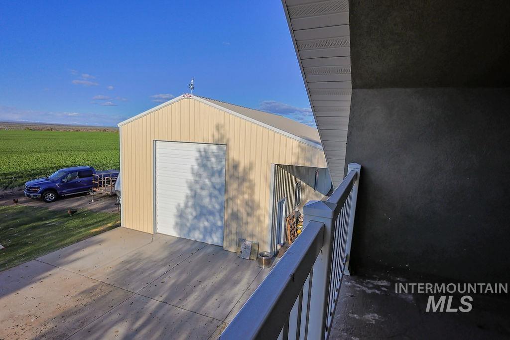 24 Harris Circle Shoshone, ID 83352 - Photo 26 of 39 View of outbuilding featuring a balcony, a rural view, and driveway