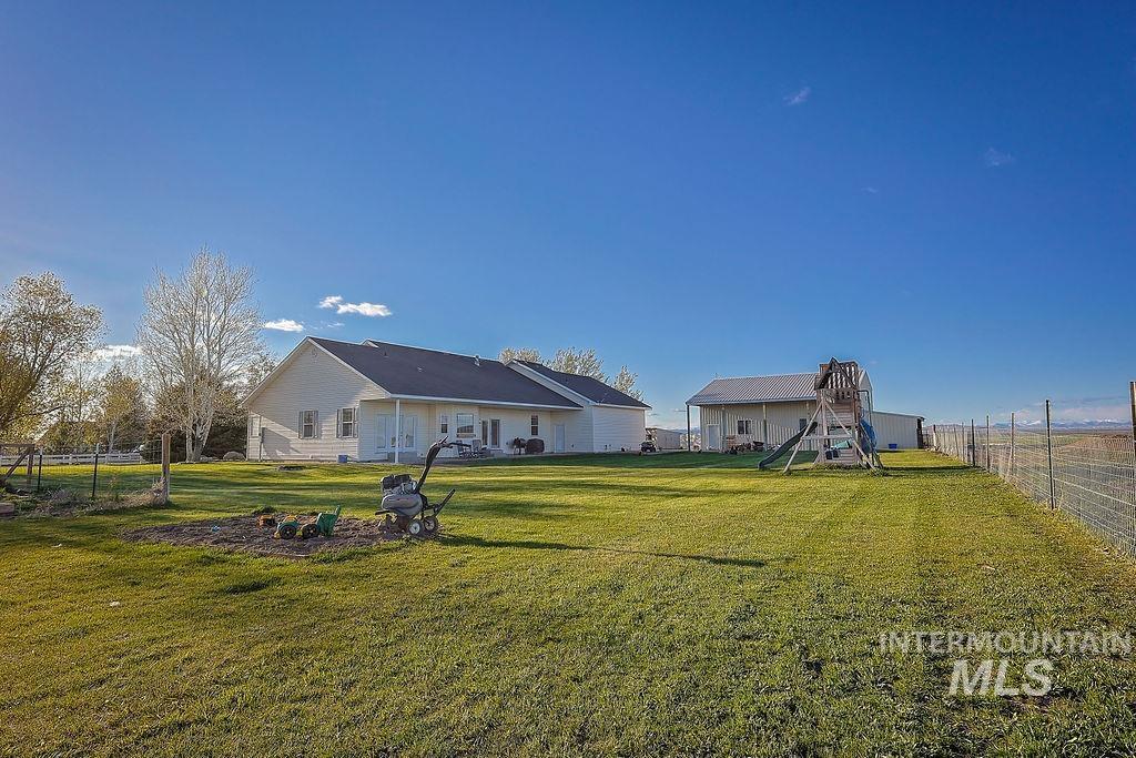 24 Harris Circle Shoshone, ID 83352 - Photo 28 of 39 Rear view of property with a fenced backyard and a patio