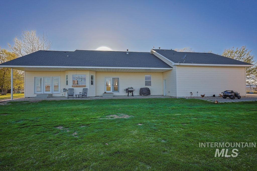 24 Harris Circle Shoshone, ID 83352 - Photo 29 of 39 Back of house featuring a patio area and a lawn