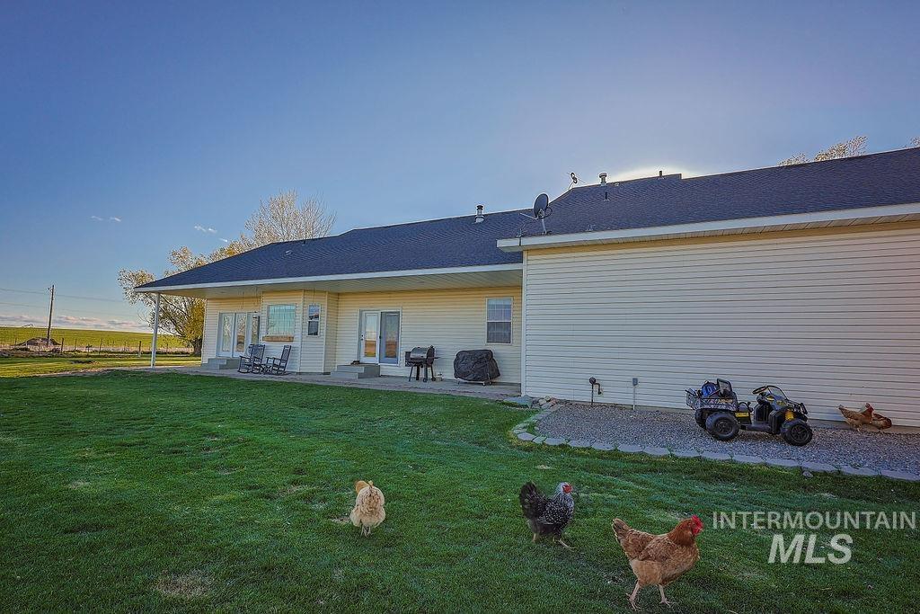24 Harris Circle Shoshone, ID 83352 - Photo 30 of 39 Back of property featuring a patio and a yard