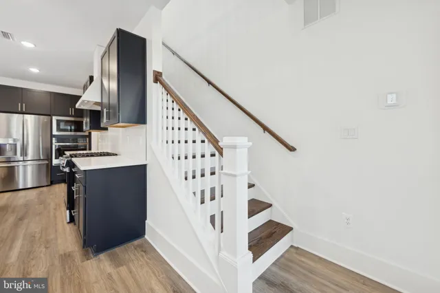 a view of entryway and hall with wooden floor