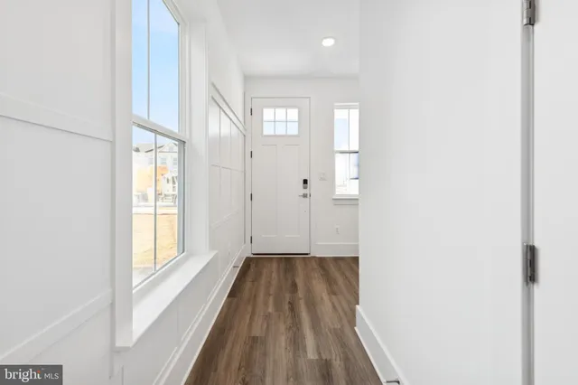 a view of a room with wooden floor and window
