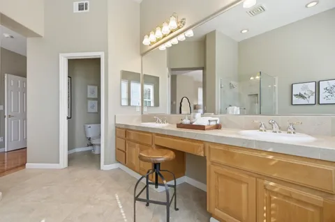 a bathroom with a tub a shower and a sink
