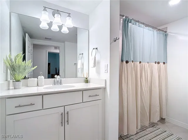 a bathroom with a double vanity sink and mirror