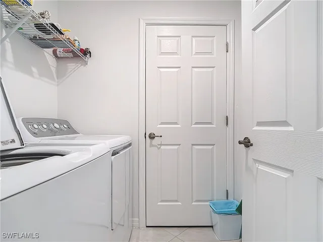 a view of a storage and utility room with a washer dryer