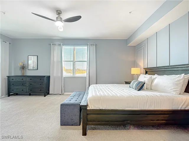 a bedroom with a bed dresser and wooden floor