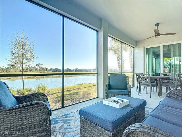 a living room with furniture and large windows