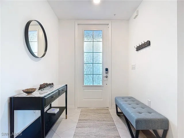 a view of a room that has a bed and a chair in it