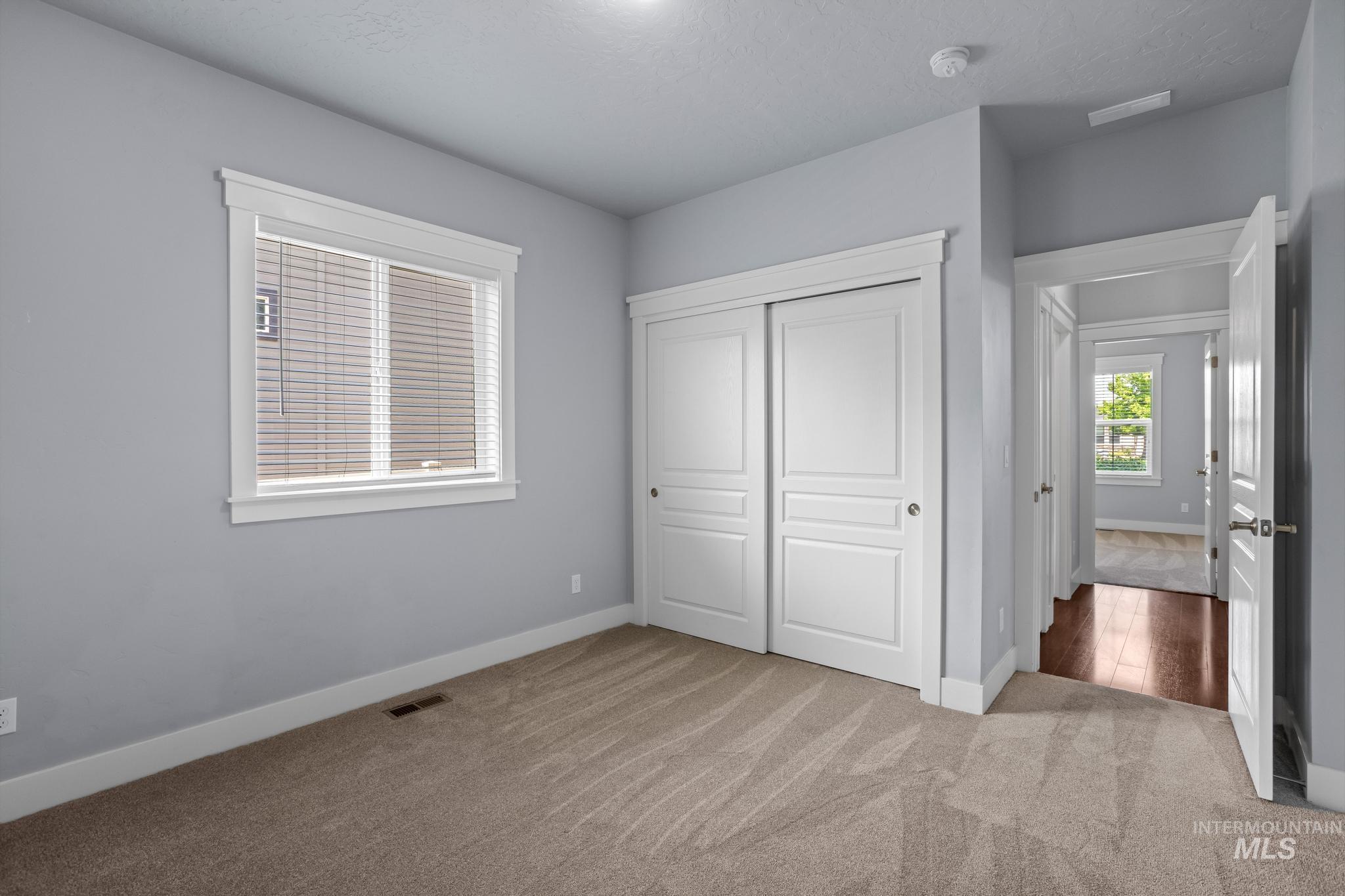 2681 East Rhyolite Court Nampa, ID 83686 - Photo 38 of 48 Bedroom featuring neutral-toned carpeting, a window with blinds, and white trim throughout