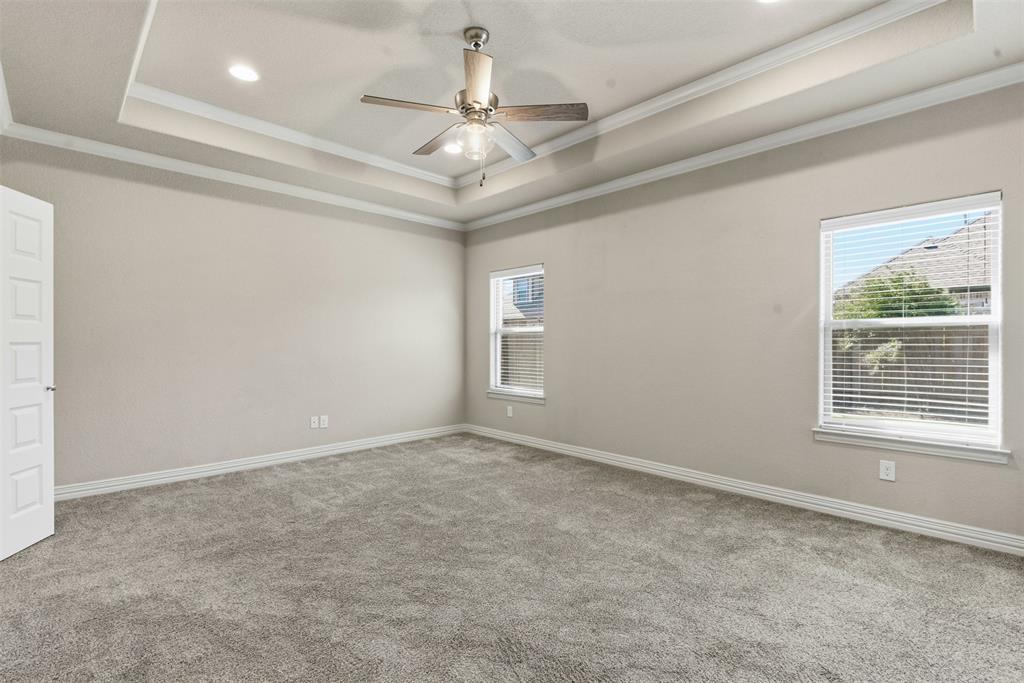 906 Chestnut Grove Drive Cleburne, TX 76033 - Photo 13 of 29 en empty room with windows and ceiling fan