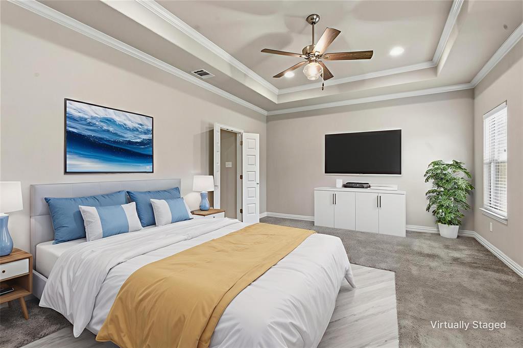 906 Chestnut Grove Drive Cleburne, TX 76033 - Photo 14 of 29 a bedroom with a large bed a flat tv screen and a ceiling fan