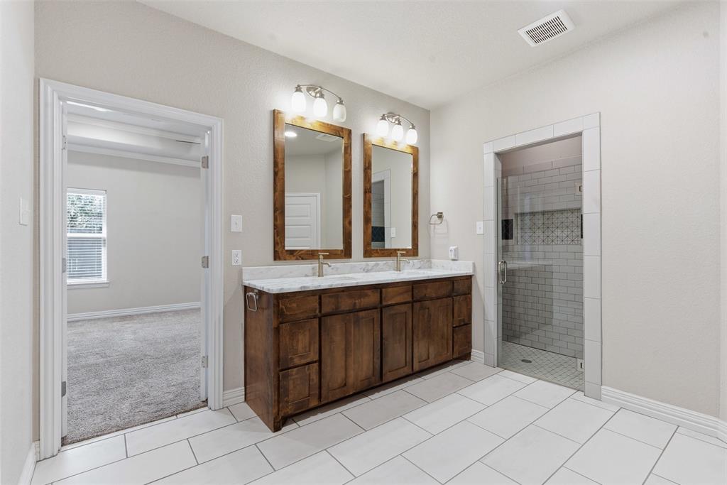 906 Chestnut Grove Drive Cleburne, TX 76033 - Photo 18 of 29 a bathroom with a double vanity sink mirror and shower