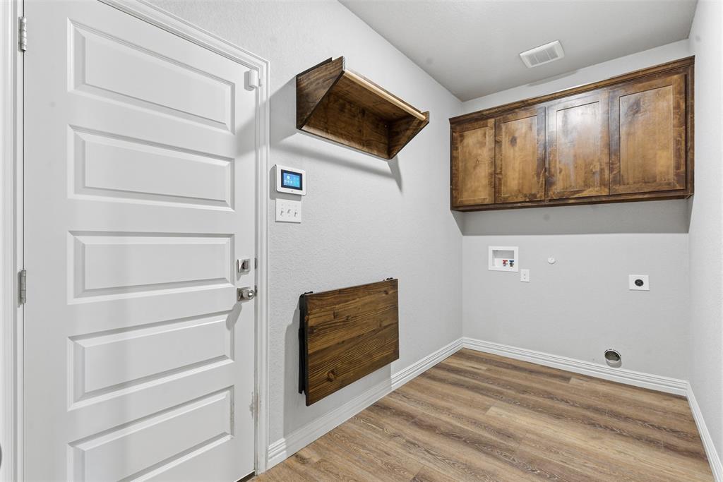 906 Chestnut Grove Drive Cleburne, TX 76033 - Photo 21 of 29 a view of empty room with wooden floor and fan