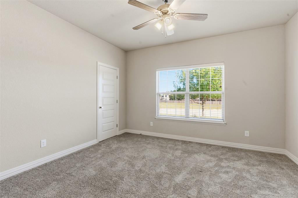 906 Chestnut Grove Drive Cleburne, TX 76033 - Photo 24 of 29 an empty room with a window and a fan