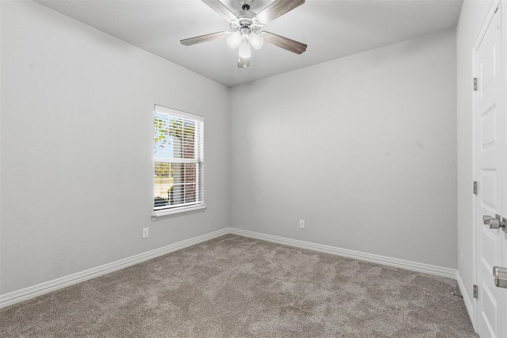 906 Chestnut Grove Drive Cleburne, TX 76033 - Photo 25 of 29 an empty room with a window and a fan