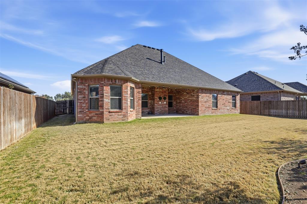 906 Chestnut Grove Drive Cleburne, TX 76033 - Photo 27 of 29 a front view of a house with a garden