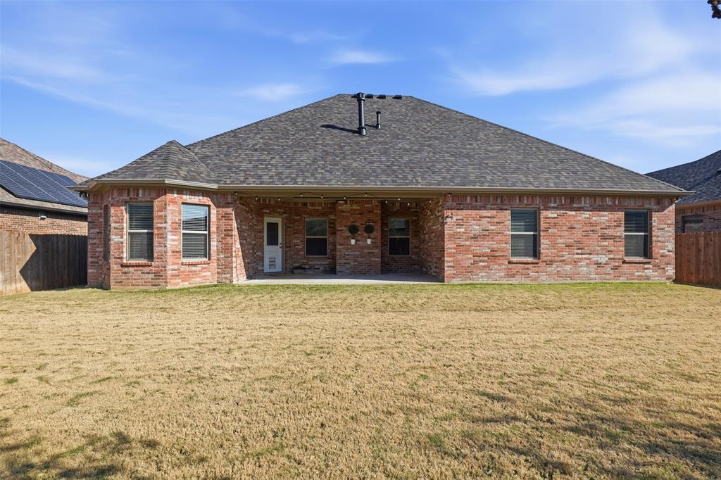 906 Chestnut Grove Drive Cleburne, TX 76033 - Photo 28 of 29 a front view of a house with a garden