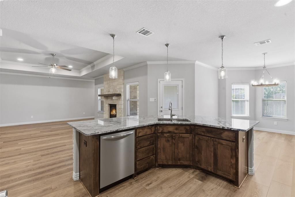 906 Chestnut Grove Drive Cleburne, TX 76033 - Photo 7 of 29 a kitchen with a sink a counter space appliances and cabinets