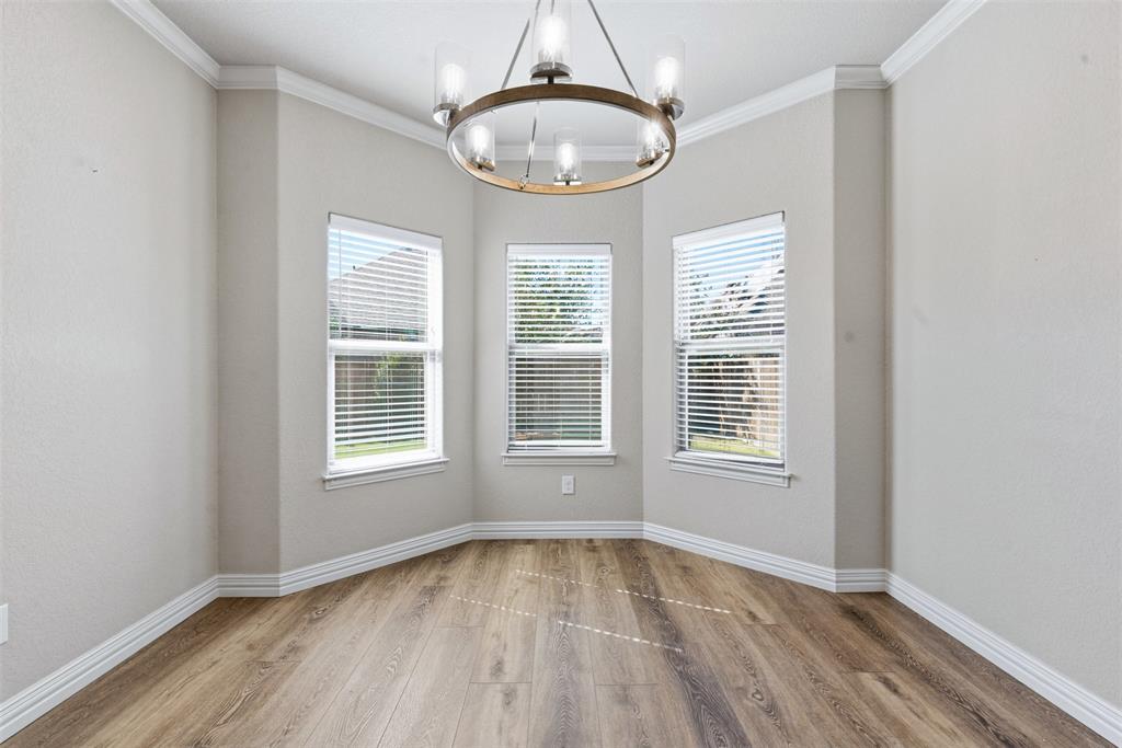 906 Chestnut Grove Drive Cleburne, TX 76033 - Photo 8 of 29 an empty room with wooden floor and windows