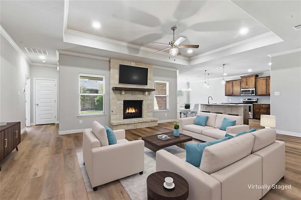 906 Chestnut Grove Drive Cleburne, TX 76033 - Photo 10 of 29 a living room with furniture a fireplace and a flat screen tv
