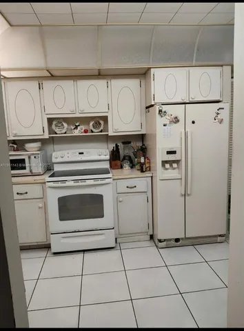 a kitchen with cabinets and appliances